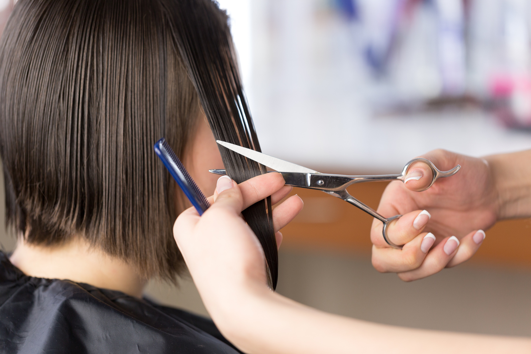 Hairdresser Cutting Woman's Hair